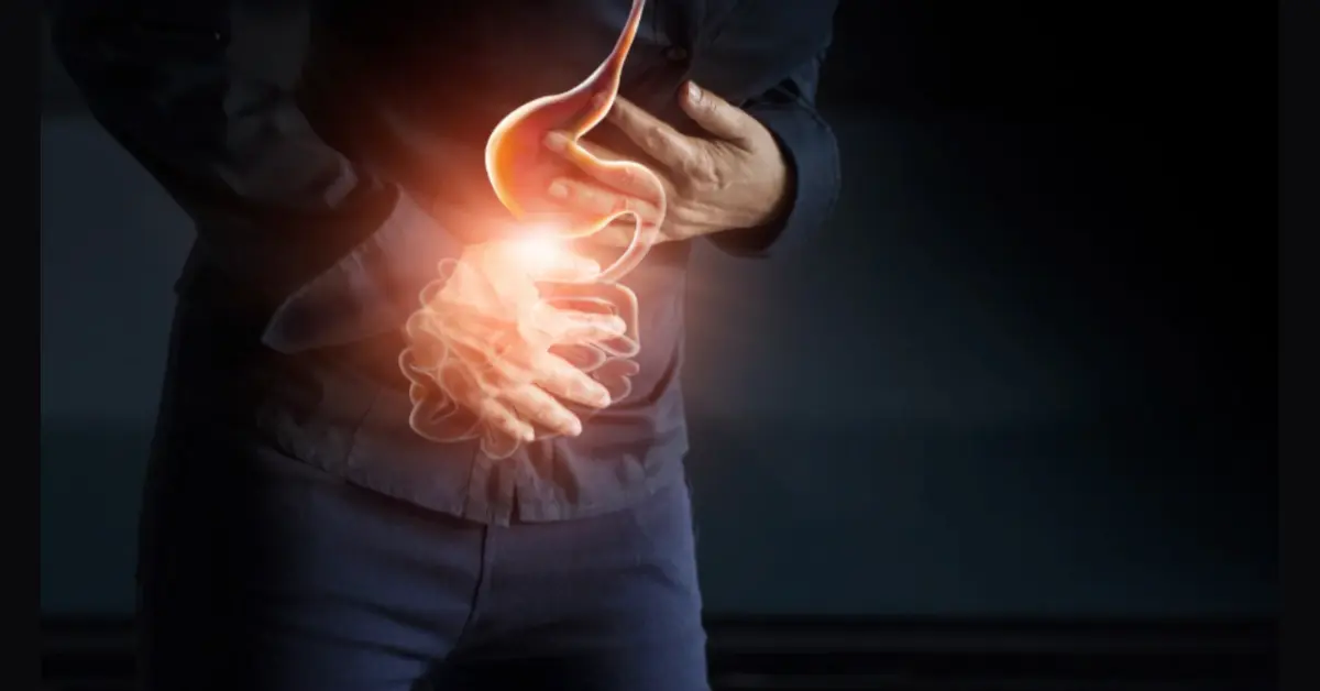 A patient holding stomach because of pain that may caused by Ulcerative Colitis